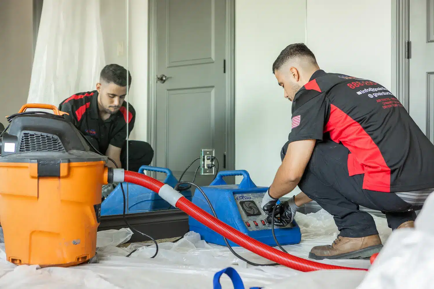 Technician setting up air duct cleaning equipment