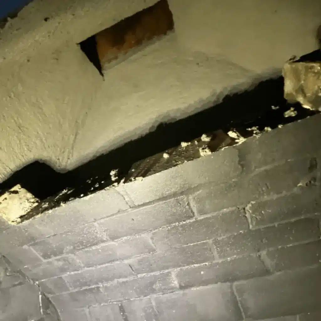 Damaged chimney interior showing cracks and deterioration before chimney leak repair