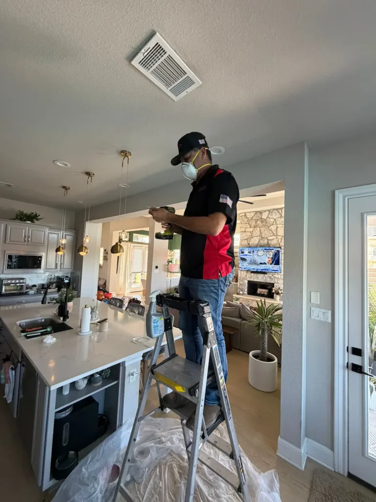 Go Air Ducts technician working on ceiling vent