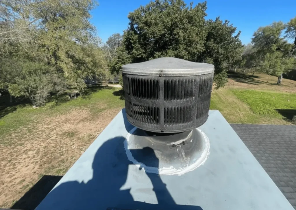 New chimney top cover with rooftop vent installed on rebuilt chimney chase