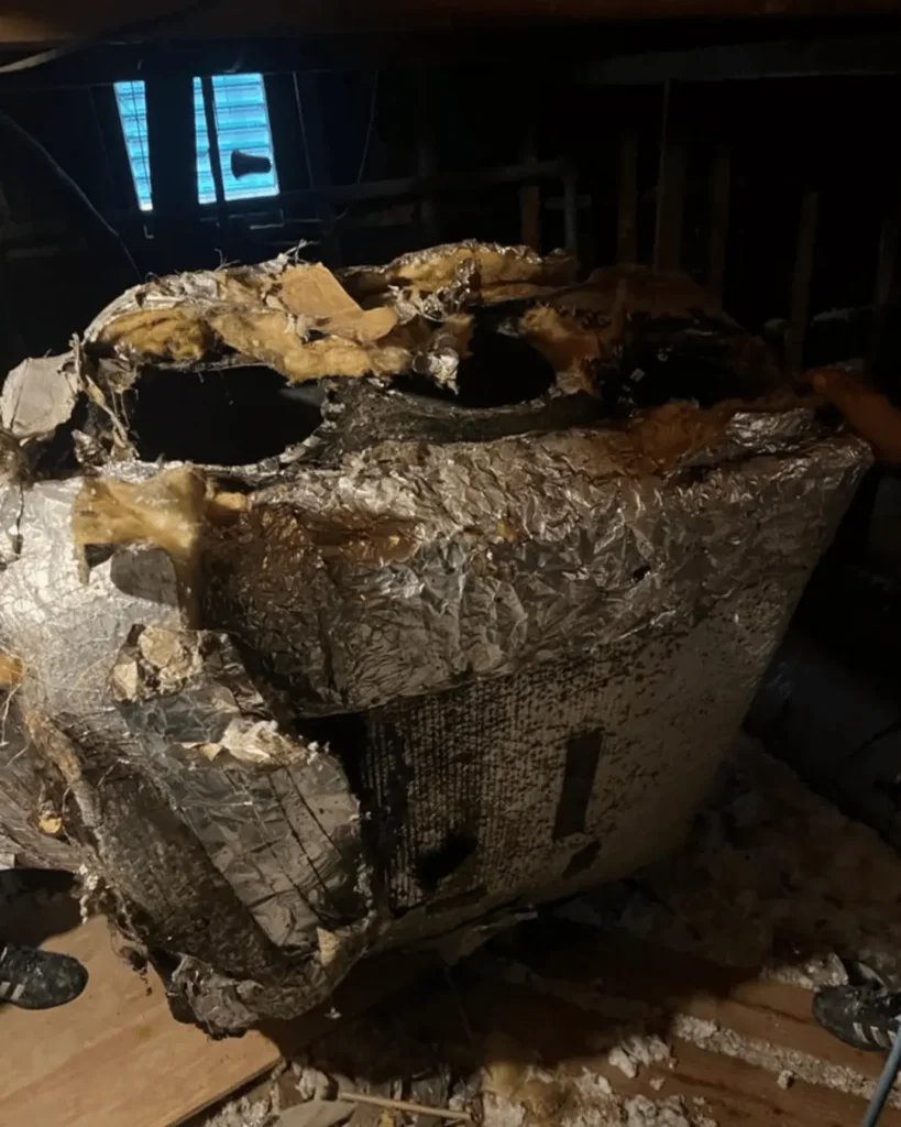 Old damaged attic HVAC unit before removal and replacement