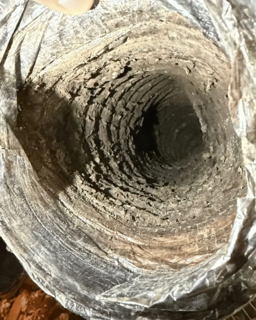 Dirty air duct filled with dust buildup