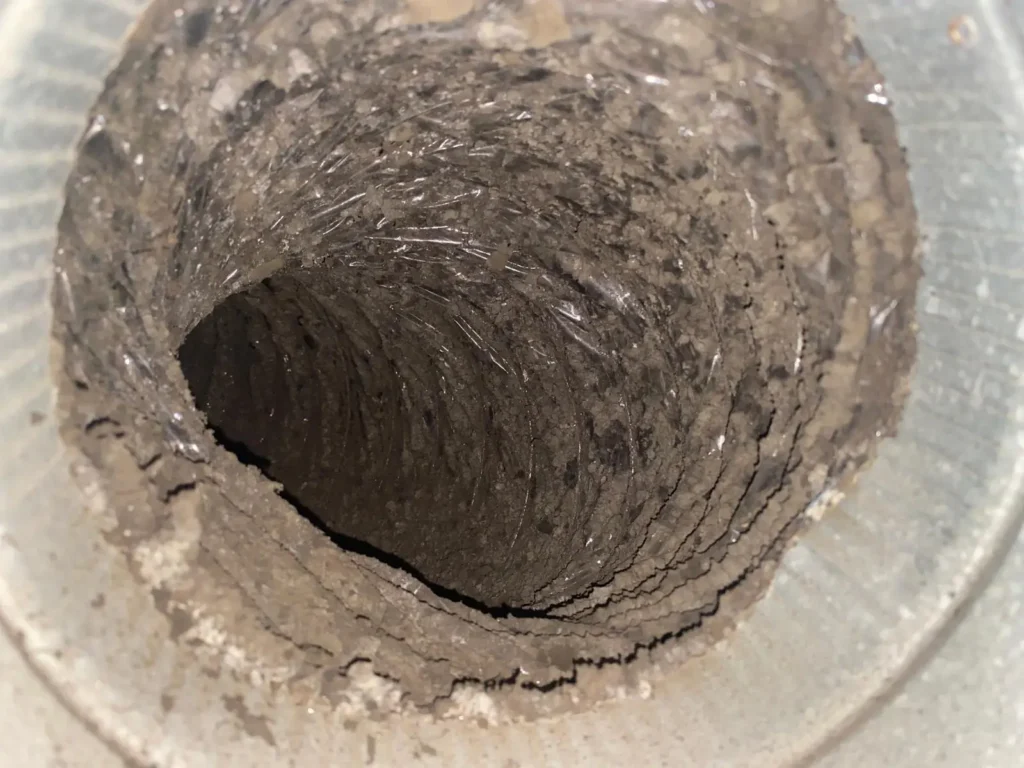 Dust-filled dryer vent interior before service